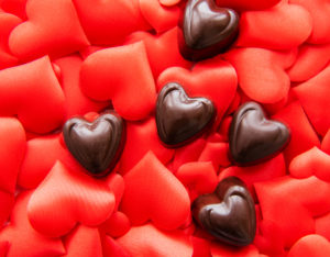 Multiple red hearts with five chocolate hearts on top